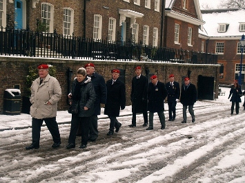Member of the branch and guests walking through the snow to the parade area